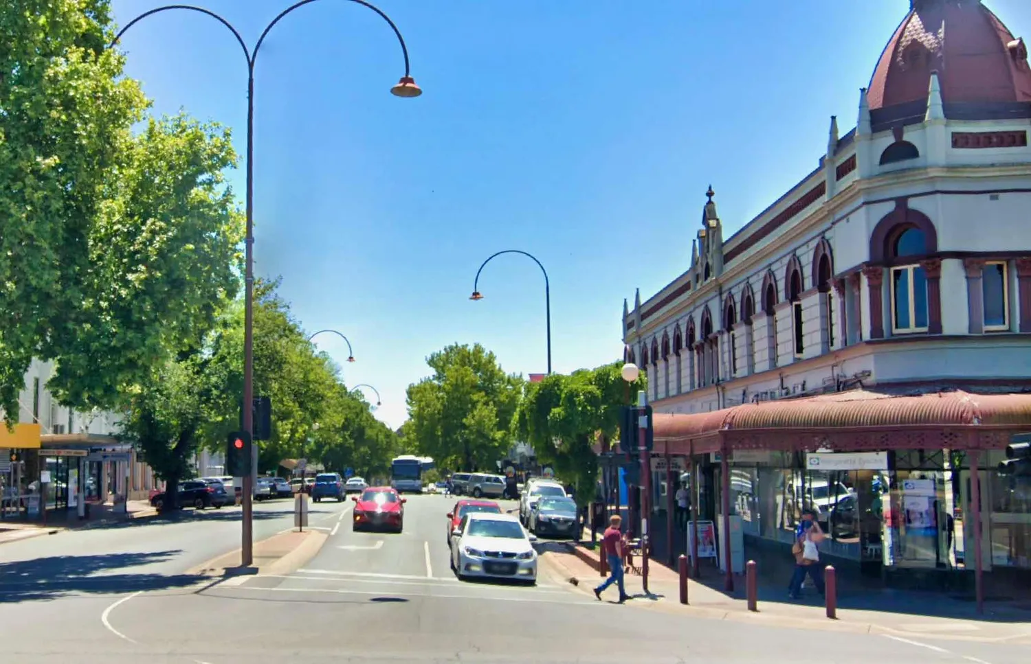 Ornate corner building and street lamps on a sunny Wangaratta street